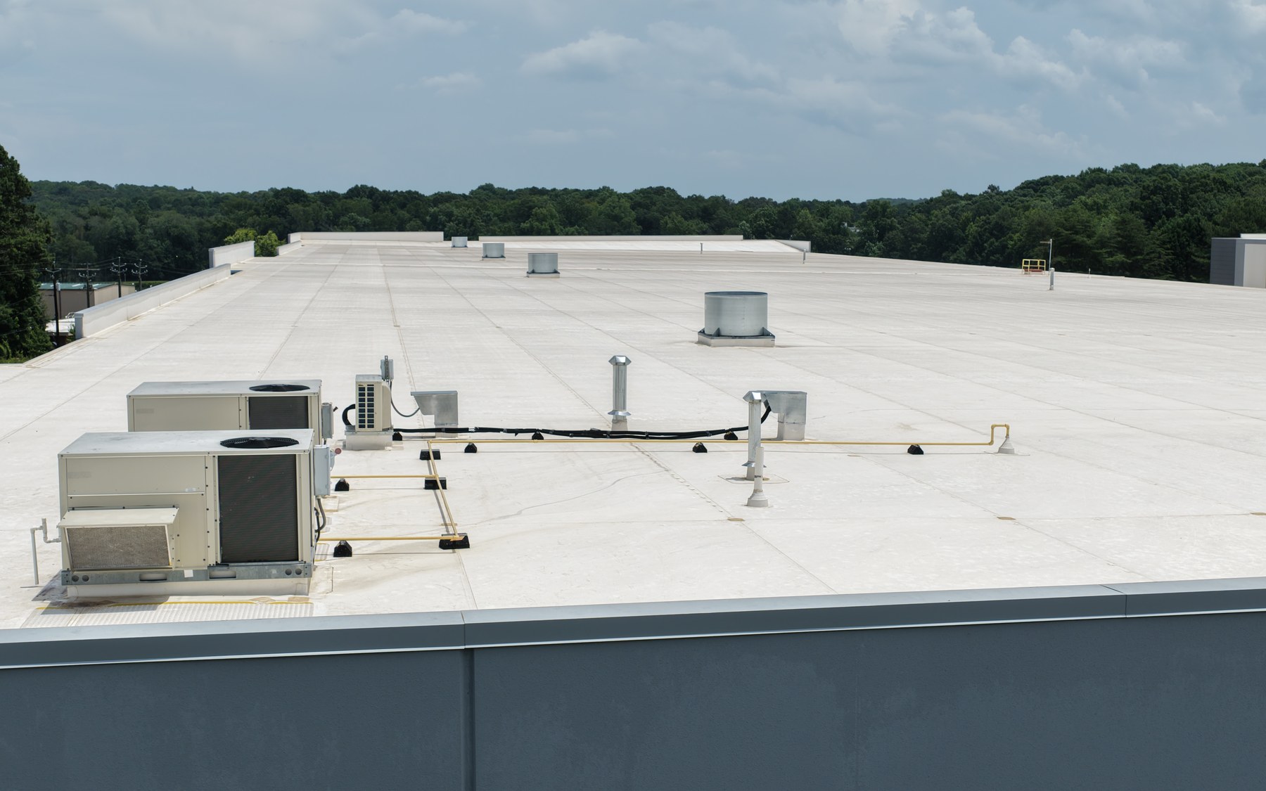 Aerial view documenting a commercial roof surface, rooftop equipment, and visible exterior conditions